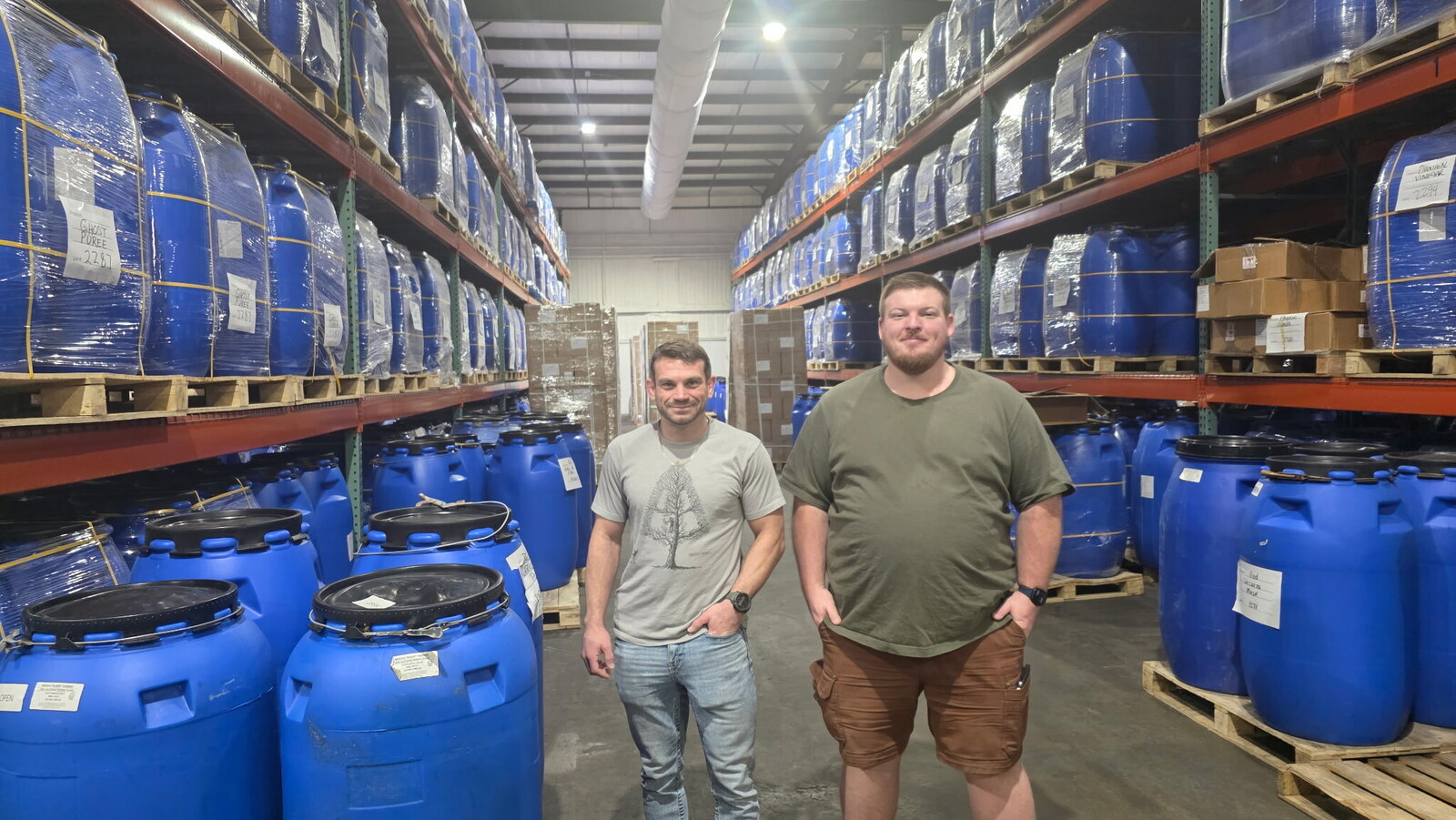 Gabe and Matthew at a warehouse of peppers in barrels